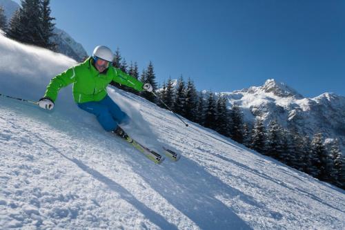 a person is skiing down a snow covered slope at Haus Panoramablick in Abtenau