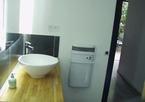 a bathroom with a sink and a toilet at Gîte La Capitelle in Boissières