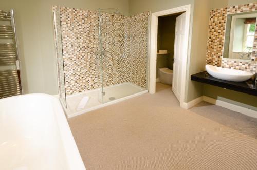 a bathroom with a shower and a toilet and a sink at Eltermere Inn in Elterwater