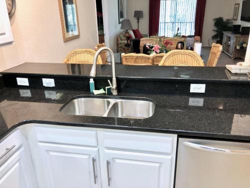 a kitchen with a sink and a counter top at Bahama Bay, Grand Bahama spacious 3-bedroom Penthouse near Disney in Kissimmee