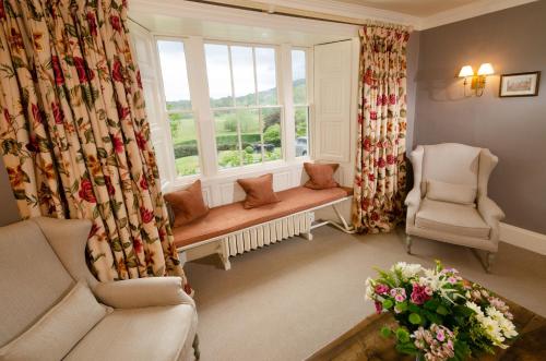 a living room with a window and two chairs at Eltermere Inn in Elterwater
