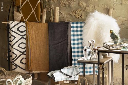 a room with a table with towels and other items at Le 19-21 - Un amour d'hotel in Leucate