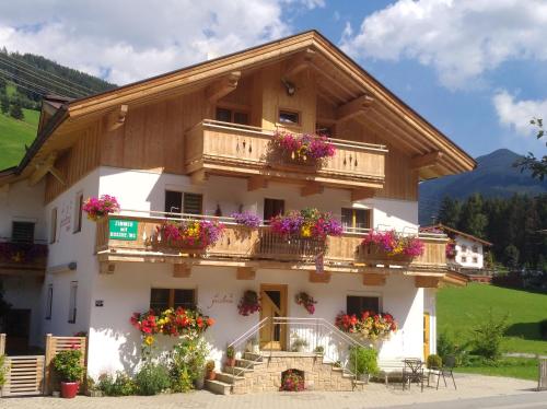 a building with flower boxes on the balconies at Gästehaus die geislerin in Gerlos