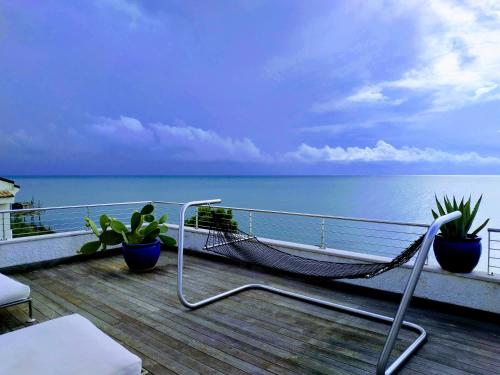 a hammock on a balcony overlooking the ocean at B&B alla Canale in Vasto