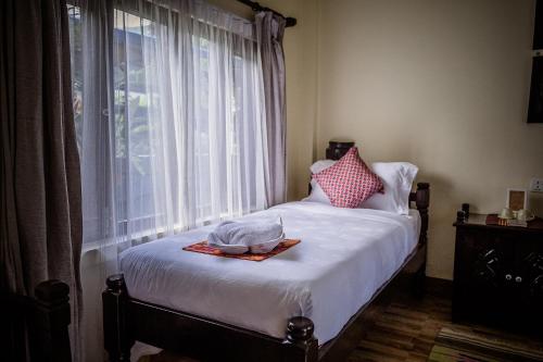 Letto o letti in una camera di Mingtang Boutique Cottage 名堂花园度假屋