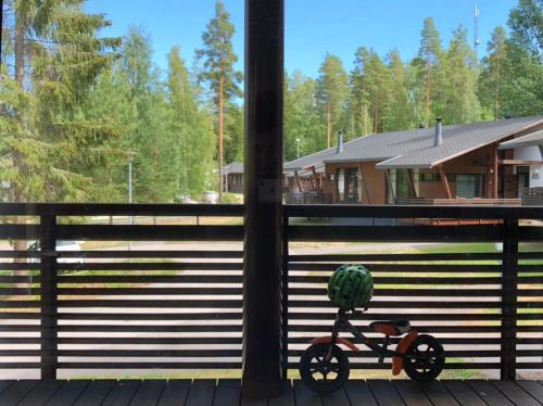 a small bike with a plant on it sitting on a porch at Saimaa Style Spa Chalet in Imatra