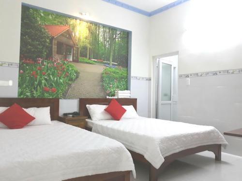 Queen Motel Vung Tau tesisinde bir odada yatak veya yataklar