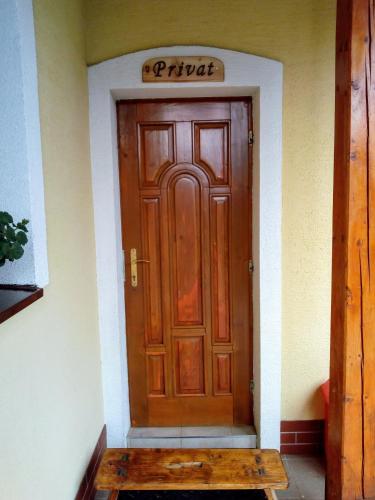 a wooden door with a bench in front of it at Apartmán " Matej" in Smrečany