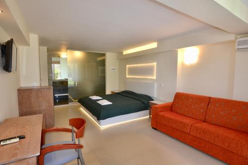 a living room with a bed and a couch at Paloma Blanca in Dassia