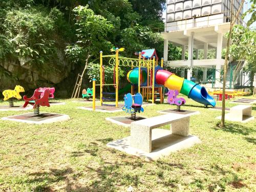 a playground in a park with a colorful playground at Home Away From Home In Taiping - Newly Upgraded! in Taiping
