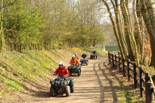 a group of people riding atvs down a dirt road at Eden Park Hotel Restaurant in Pont-lʼÉvêque