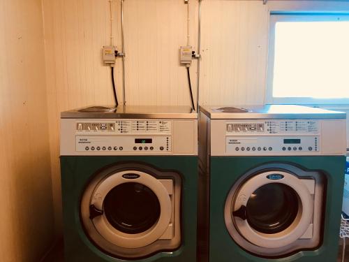 two washing machines sitting next to each other at Klackbergsgården in Norberg