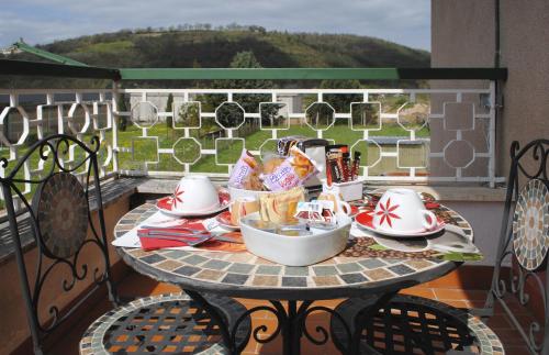 uma mesa com pratos e chávenas numa varanda em A casa di Gianna B&B em Rieti