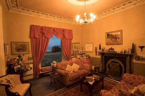 a living room with a couch and a fireplace at Gaultier Lodge in Woodstown