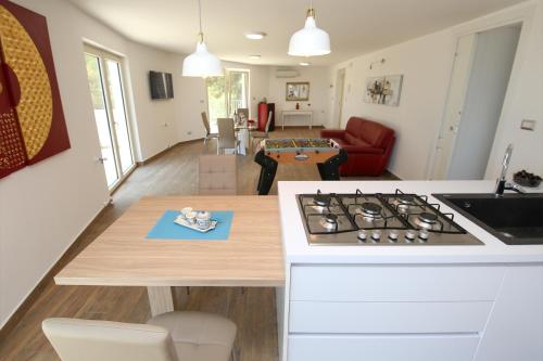 a kitchen and living room with a stove top at villa aurora in Giardini Naxos
