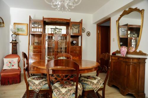 a dining room with a wooden table and a mirror at Casa Foscolo in Ferrara