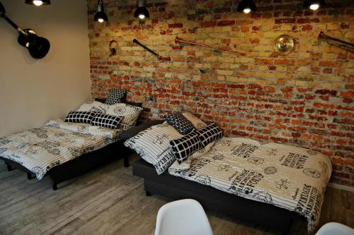 Ένα ή περισσότερα κρεβάτια σε δωμάτιο στο Art Music Loft Białystok