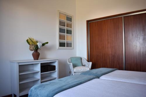 מיטה או מיטות בחדר ב-Casa das Ondas