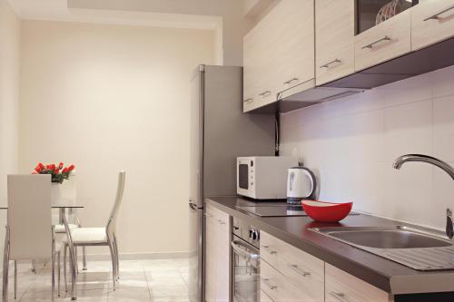 a kitchen with a sink and a counter top at Spiridoula's Apartments Corfu in Perama