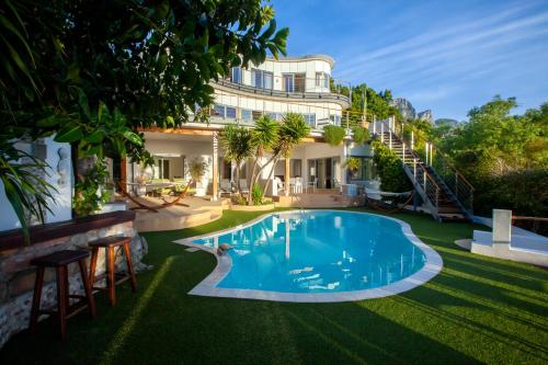 an image of a swimming pool in front of a house at Ocean Lounge in Cape Town