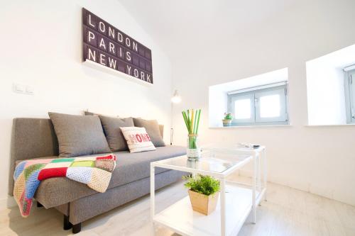 a living room filled with furniture and a window at MalagaUrbanRooms - Central Suites in Málaga