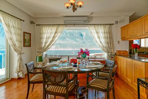 a dining room with a table and chairs with a view at Villa Poseidon-in winter heated outdoor pool in Kas