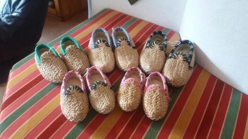 a group of pairs of shoes sitting on a table at Gästehaus Marianne Baier in Zederhaus