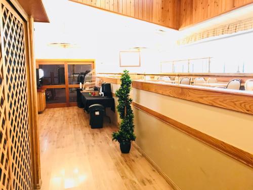 a lobby with a waiting room with a potted plant at Northern Star Hotel & Convention Center in Slave Lake