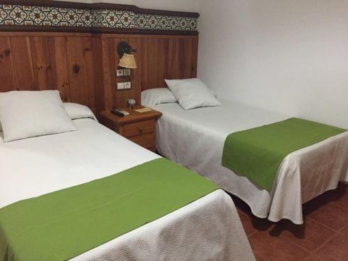 a hotel room with two beds and a desk at Casa Francisco el de Siempre in El Palmar