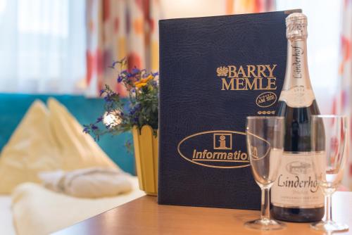 a bottle of champagne and a glass on a table at Barry Memle Directly at the Lake in Velden am Wörthersee