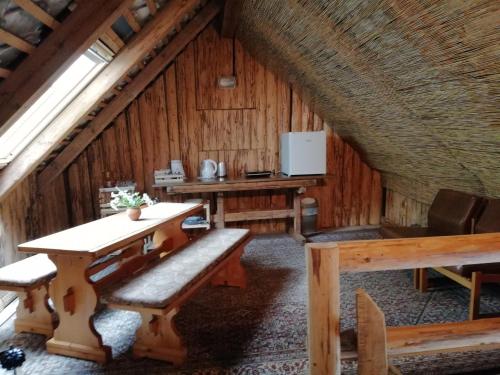 a room with a table and benches in a cabin at PR`Cajhn in Radovljica