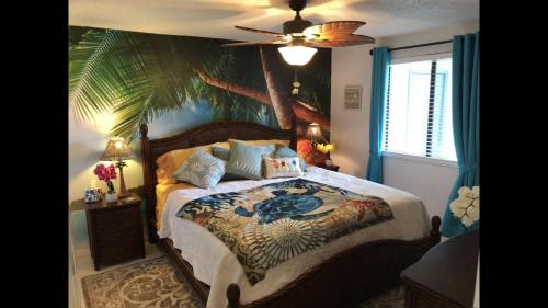a bedroom with a bed with a palm tree mural at 2 Bedroom , 2 Bath , Villa in Oldsmar