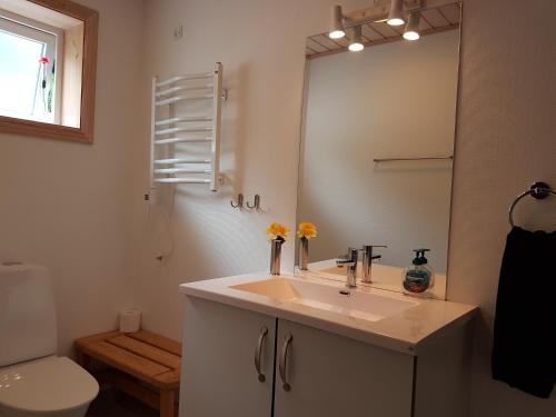 a bathroom with a sink and a mirror at Comfy in the center in Tórshavn