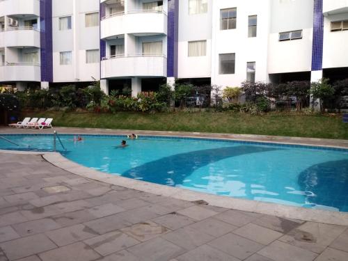 a swimming pool in front of a apartment building at Apart no Águas da Serra - 115B in Rio Quente