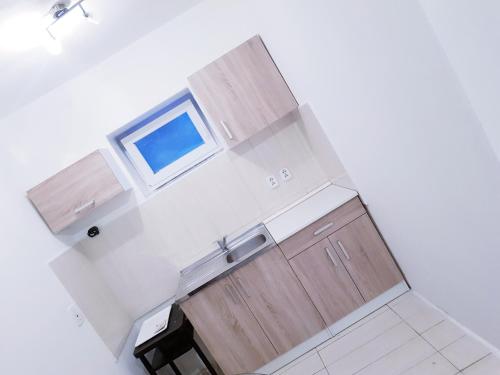 an overhead view of a kitchen with wooden cabinets at Apartman La Martina in Vráble