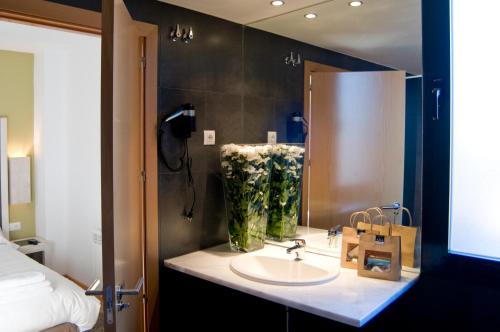 a bathroom with a sink and a mirror at Hospedium Hotel Convento de Santa Ana in Atienza