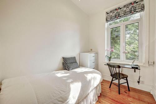 a bedroom with a bed and a desk and a window at Hampstead Stylish Apartment Brilliant Location in London