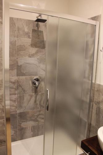 a shower with a glass door in a bathroom at B&B Fine Venice in Marghera