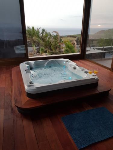 a hot tub sitting in a room with a window at Villa Tejeguate in Frontera