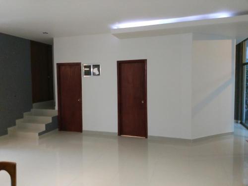 a hallway with two doors and stairs in a building at Casa Zen in Pachuca de Soto