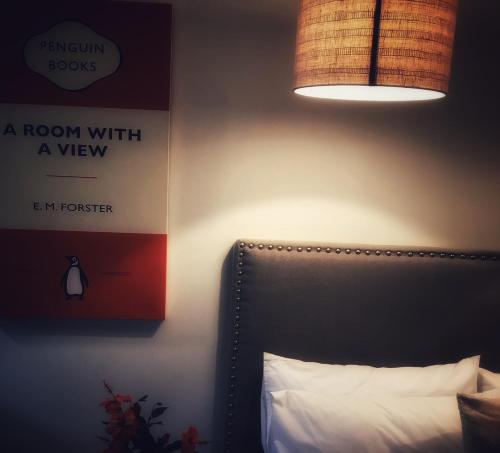 a bedroom with a bed with a lamp and a pillow at Stay Kerikeri in Kerikeri