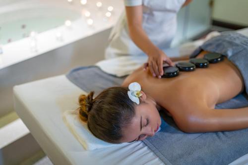 a woman getting a massage in a salon at Little Riverside Hoi An . A Luxury Hotel & Spa in Hoi An