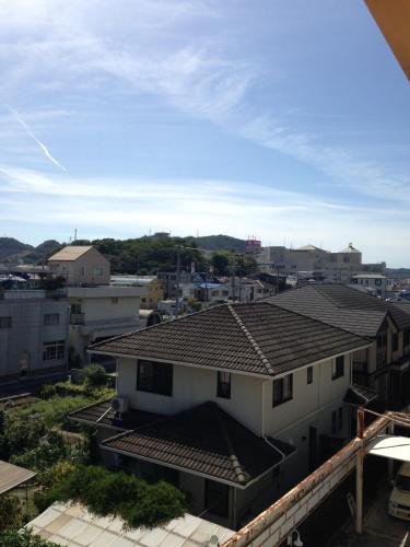 a view of a house with a roof at ホテル カルネヴァール 男塾ホテルグループ in Himeji