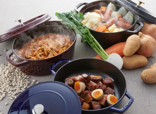 a table with two pots of food and vegetables at HOTEL VISCHIO AMAGASAKI by GRANVIA in Amagasaki