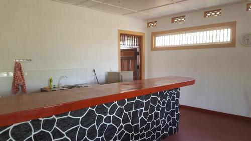 a kitchen with a counter top in a room at Sampalthivu Beach Villa in Trincomalee