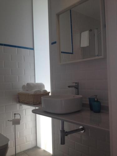 a white bathroom with a sink and a mirror at Montebreamo in Puentedeume