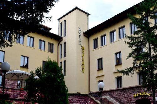 a building with a sign on the side of it at Hotel Jeravna in Bankya