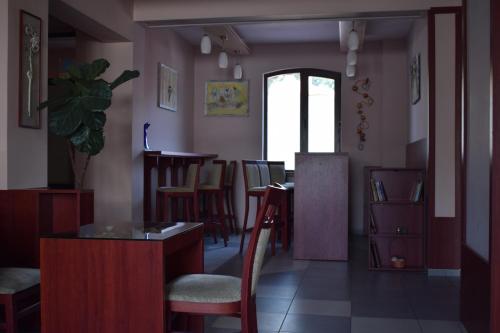 a living room with a table and chairs at Hotel Jeravna in Bankya