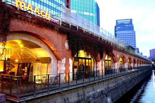 a bridge over a river in a city with buildings at 1 Night 1980 Hostel Tokyo Asakusa Simple Stay in Tokyo