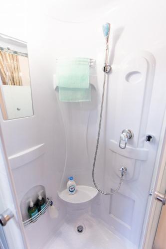 a bathroom with a shower with a toilet and a sink at YokohamaKannai HouseBar in Yokohama